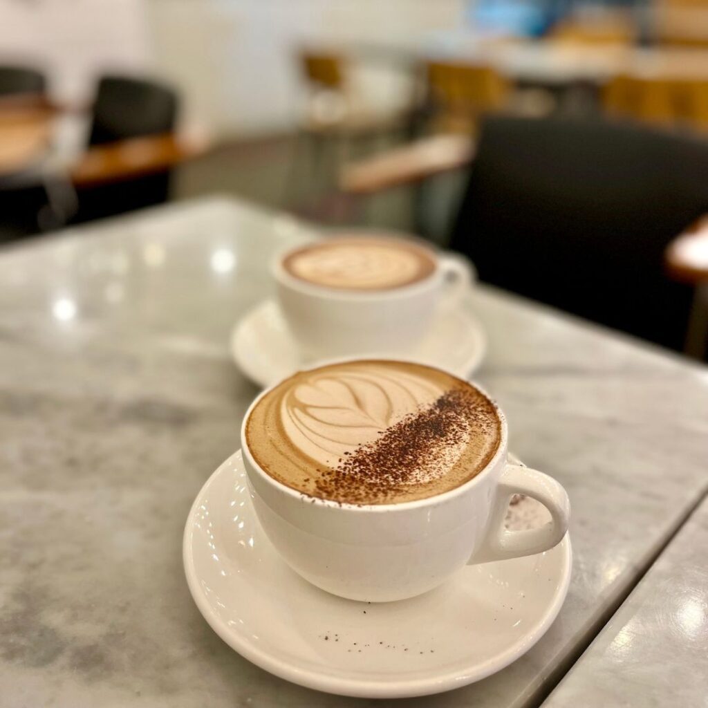 White ceramic coffee cup on a plate with latte art
